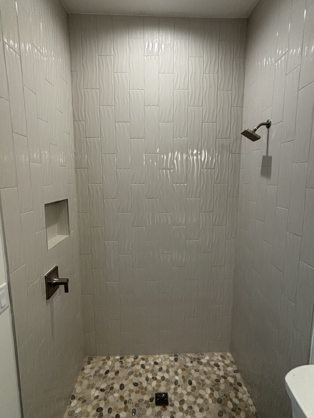 Discover 10 health benefits of natural stone shower floors, from reflexology to improved air quality. Learn how Legacy Interior Services creates wellness-focused bathrooms.