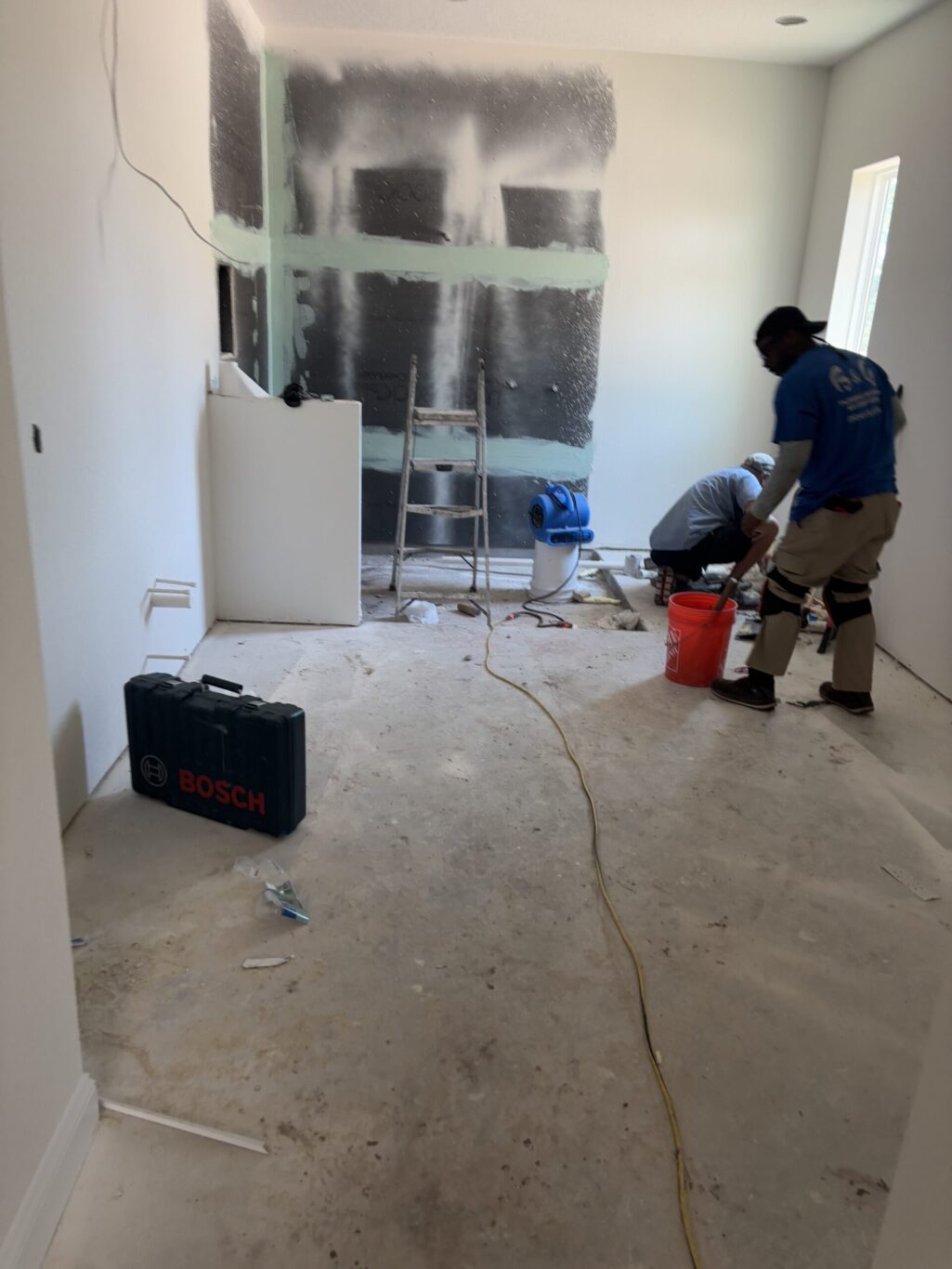 "Freshly sloped mortar mud bed packed into a custom walk in shower base ready for tile installation"
